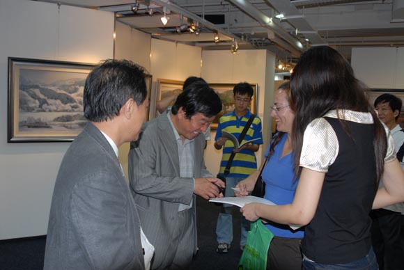 在新加坡傅强画展开幕式上，傅强教授在和英国画家交流